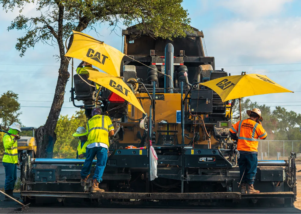 carolina asphalt worker team using a machine for asphalt paving