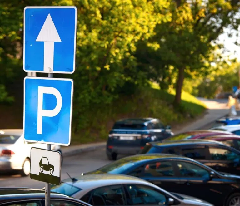 Blue and white Close-up of Parking Sign in neighborhood