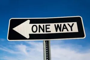 one way, black and white traffic sign pointing left