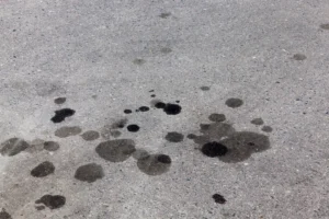 oil and other discolored spots on pavement