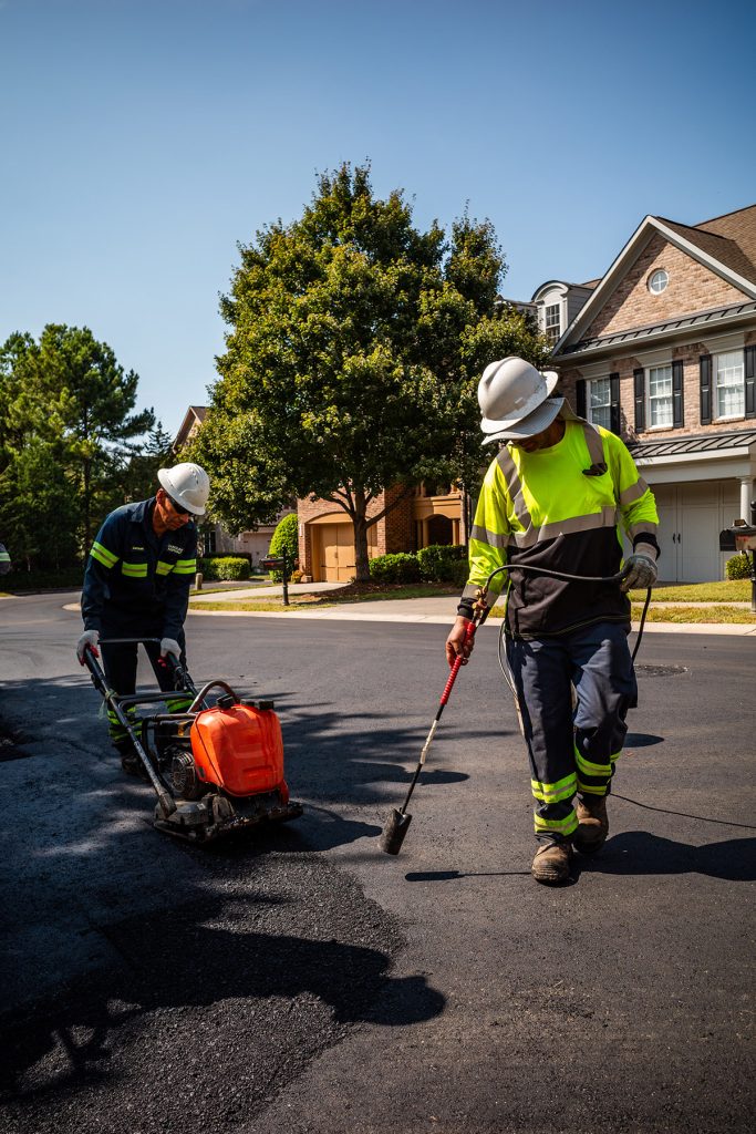 two construction workers working on the road