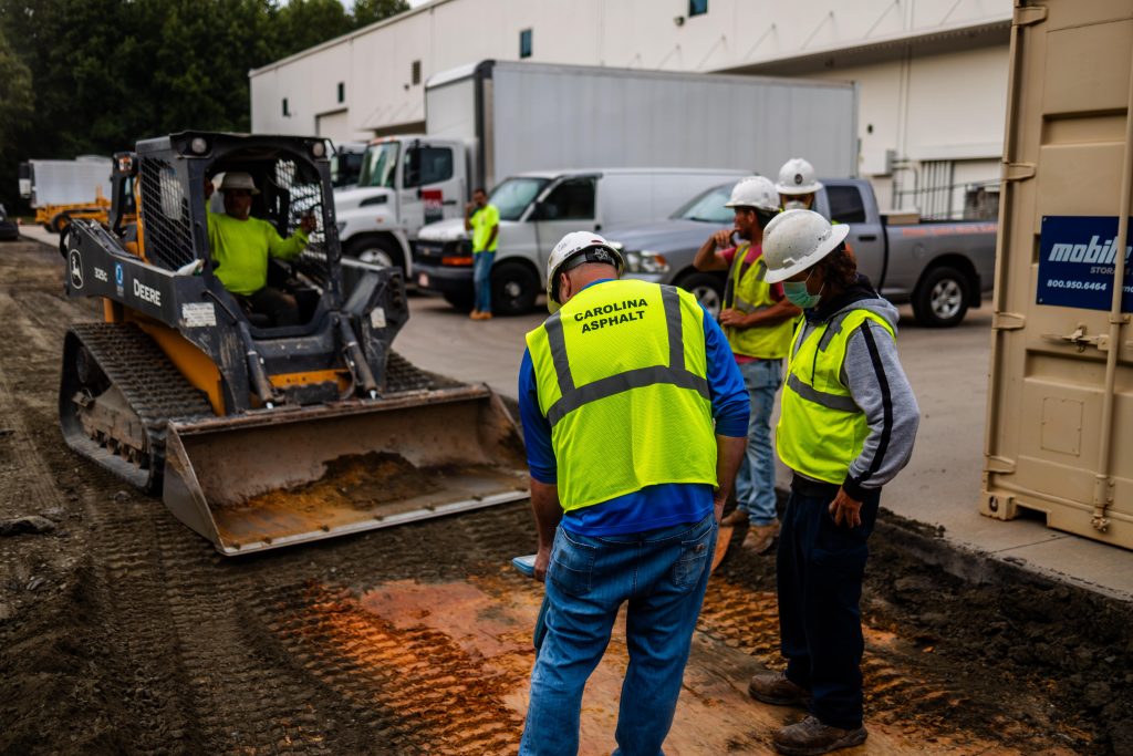carolina asphalt workers performing the blending step in full depth reclamation process