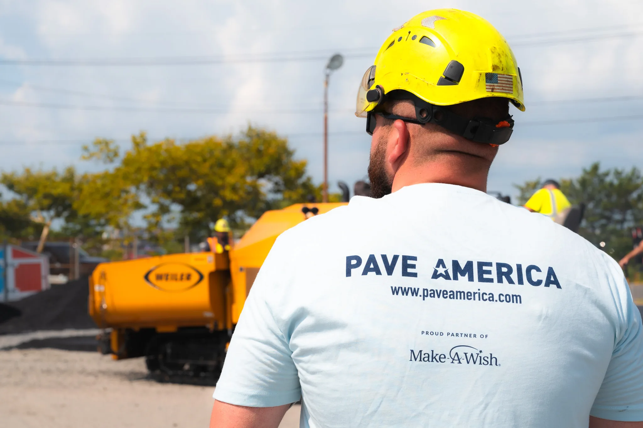 back of a shirt on a paving contractor that depicts the partnership between pave america and make a wish