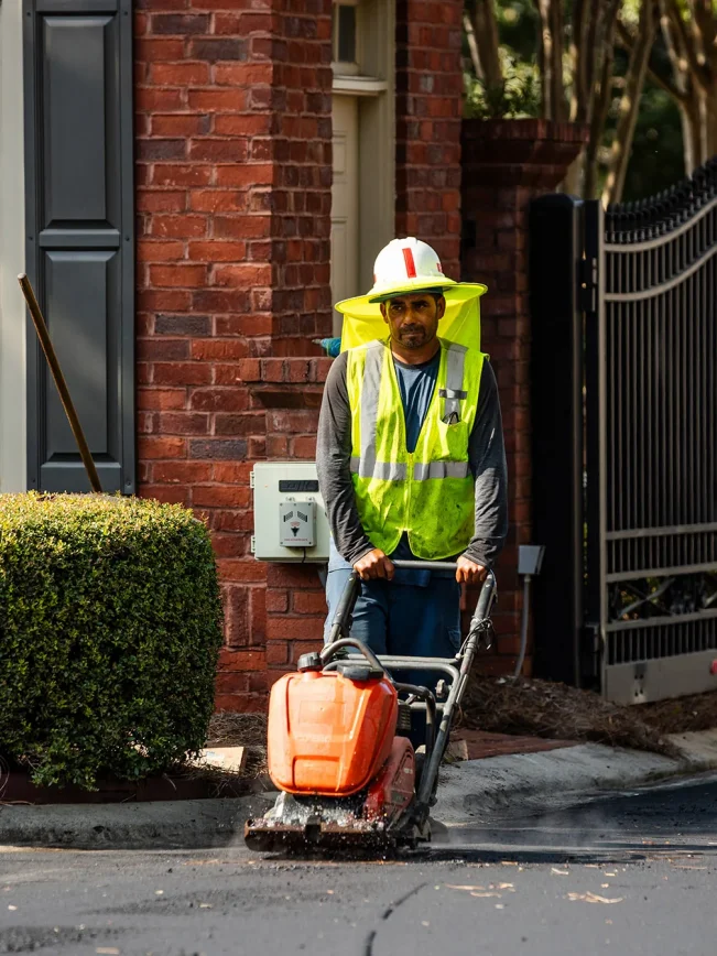 man with a paving machine in safety gear