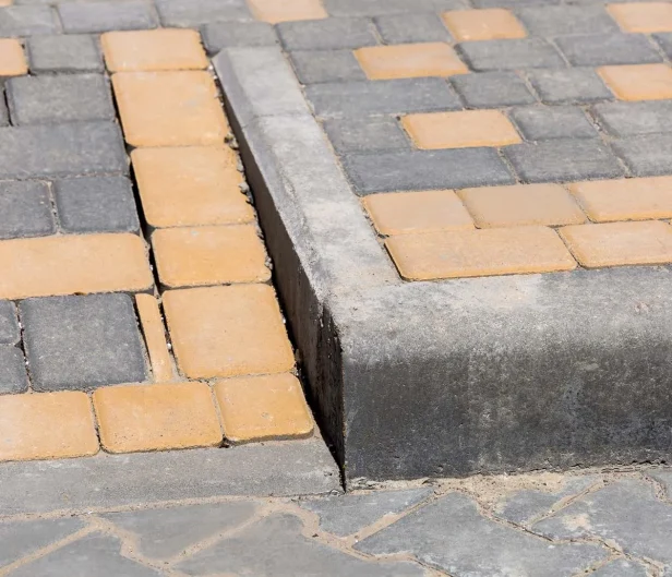 Curb ramp on concrete sidewalk to increase accessibility, ADA ramp requirements are always followed with Carolina Asphalt.