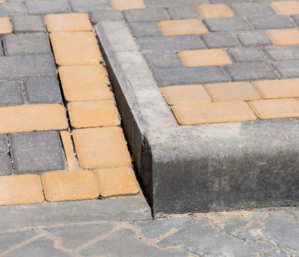 Curb ramp on concrete sidewalk to increase accessibility, ADA ramp requirements are always followed with Carolina Asphalt.