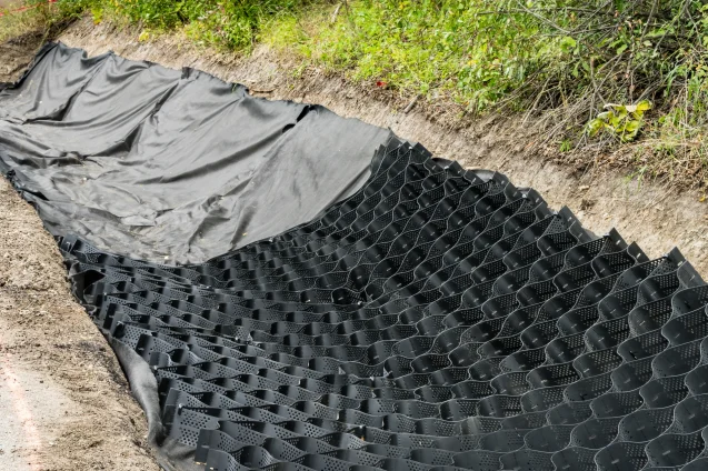 soil stabilization device being laid in a trench